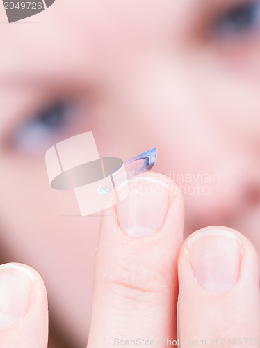 Image of Close up of inserting a contact lens