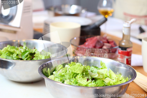 Image of Green salad leaves are on a kitchen
