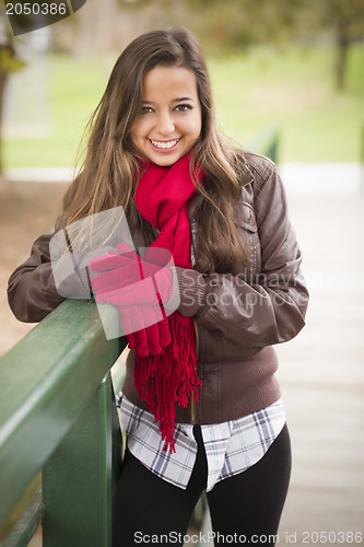 Image of Pretty Woman Portrait Wearing Red Scarf and Mittens Outside