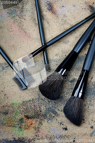 Image of Five brushes on a dingy background