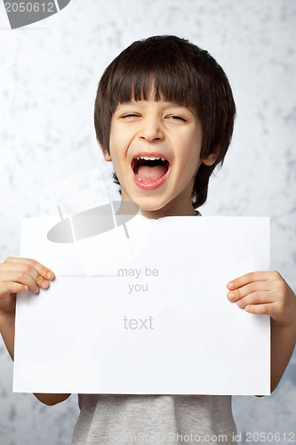 Image of laughing boy with a poster in hands