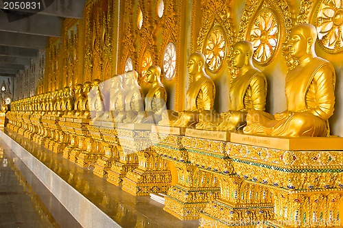 Image of row of golden monk buddhist statues in thai temple, Chaimongkhol