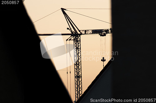 Image of building crane during sunrise