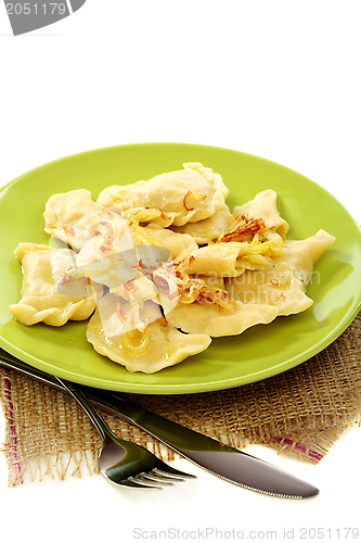 Image of Dumplings stuffed with cabbage and fried onions.