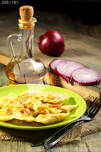 Image of Dumplings with cabbage and fried onions.