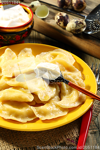 Image of Dumplings with cottage cheese and sour cream.