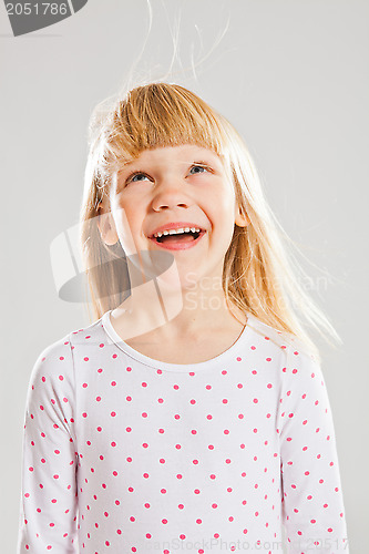 Image of Happy young girl looking up