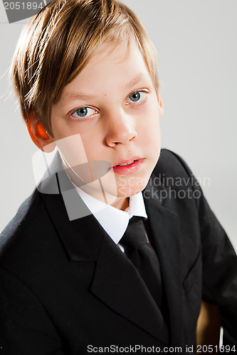 Image of Young boy wearing black suit