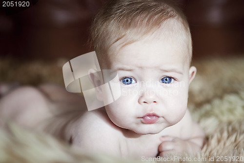 Image of Child lying on fur