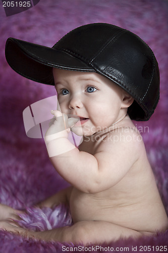 Image of Child sitting on purple fur