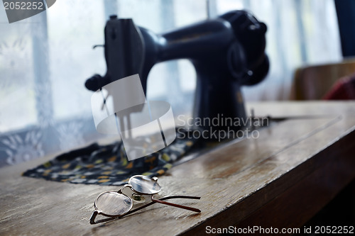 Image of Glasses and sewing machine