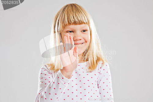 Image of Smiling young girl showing hand signal
