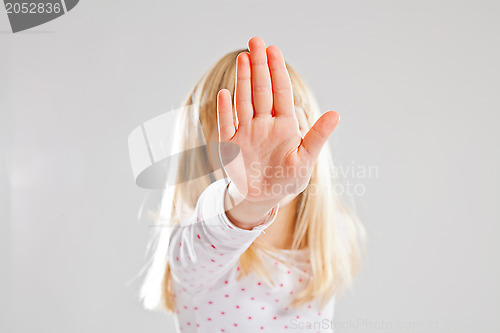 Image of Young girl showing stop hand sign