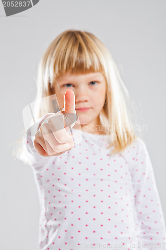 Image of Young girl showing thumbs up sign
