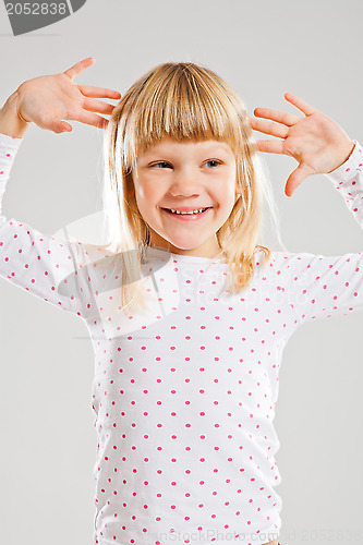 Image of Happy smiling young girl with raised hands