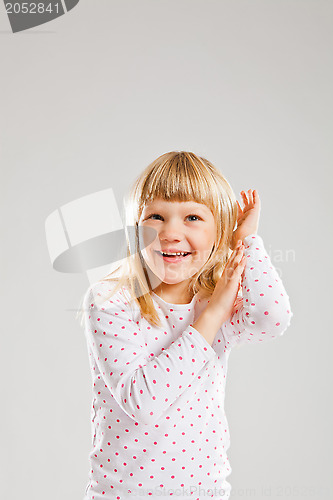 Image of Happy smiling young girl with raised hands