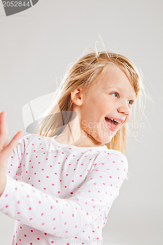 Image of Happy smiling young girl looking to side