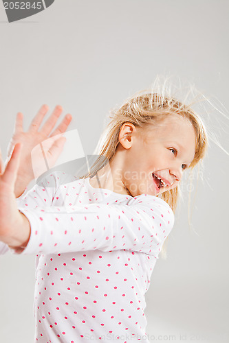 Image of Happy smiling young girl with raised hands
