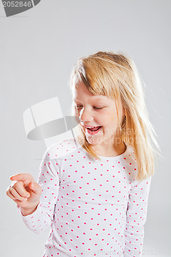 Image of Happy smiling young girl pointing