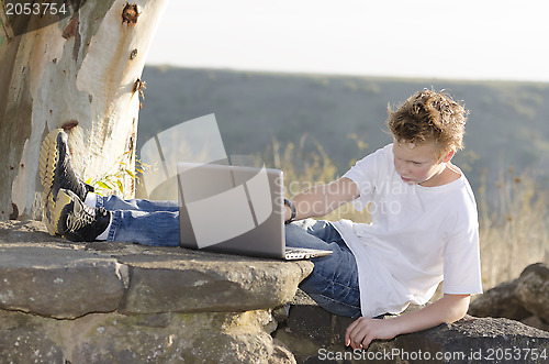 Image of Guy works on a laptop