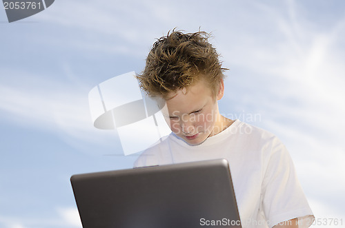 Image of Guy with notebook against sky background