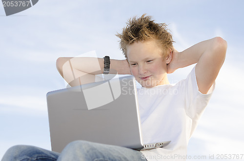 Image of Fair-haired schoolboy relaxing hands behind his head