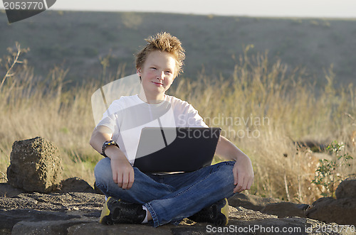 Image of Teen male with notebook
