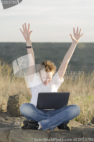 Image of Teenager joyously throws his hands up