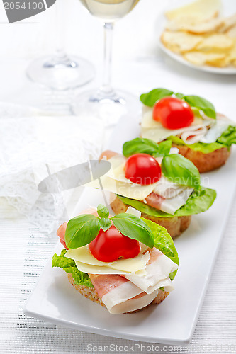 Image of Sandwich with prosciutto, parmesan cheese and tomato