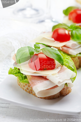 Image of Sandwich with prosciutto, parmesan cheese and tomato