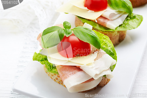 Image of Sandwich with prosciutto, parmesan cheese and tomato