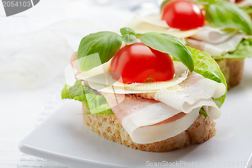 Image of Sandwich with prosciutto, parmesan cheese and tomato