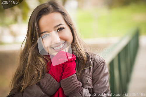 Image of Pretty Woman Portrait Wearing Red Scarf and Mittens Outside