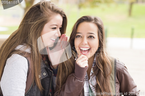 Image of Mixed Race Woman Whispering Secrets Outside