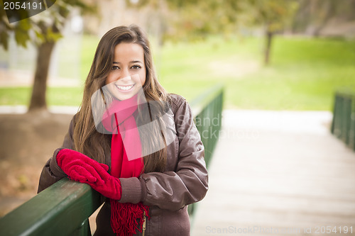 Image of Pretty Woman Portrait Wearing Red Scarf and Mittens Outside