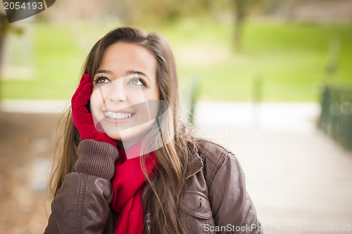 Image of Pretty Woman Portrait Wearing Red Scarf and Mittens Outside