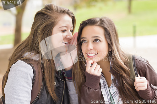 Image of Mixed Race Woman Whispering Secrets Outside