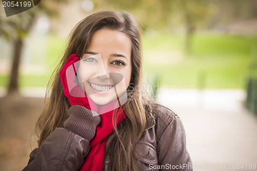 Image of Pretty Woman Portrait Wearing Red Scarf and Mittens Outside