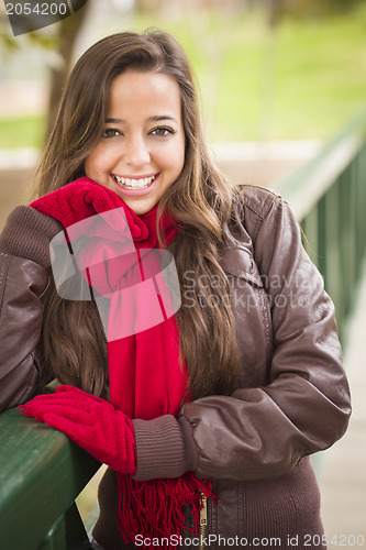 Image of Pretty Woman Portrait Wearing Red Scarf and Mittens Outside