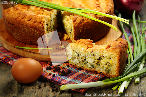 Image of Pie stuffed with eggs and onion closeup.