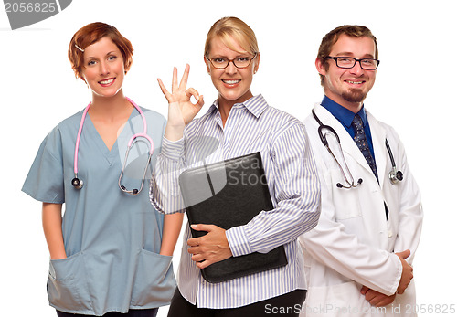 Image of Businesswoman Making Okay Hand Sign with Doctors or Nurses