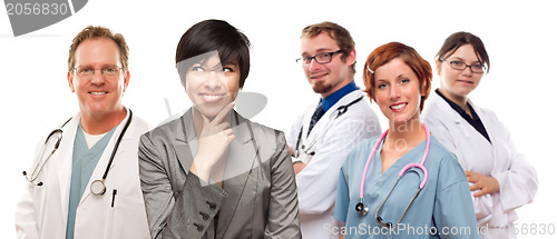 Image of Young Mixed Race Woman with Doctors and Nurses Behind
