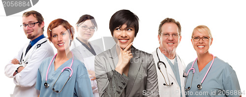 Image of Young Mixed Race Woman with Doctors and Nurses Behind