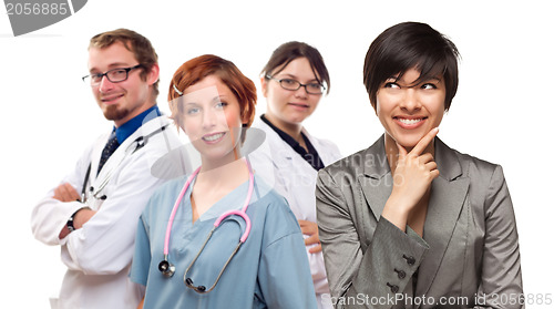 Image of Young Mixed Race Woman with Doctors and Nurses Behind
