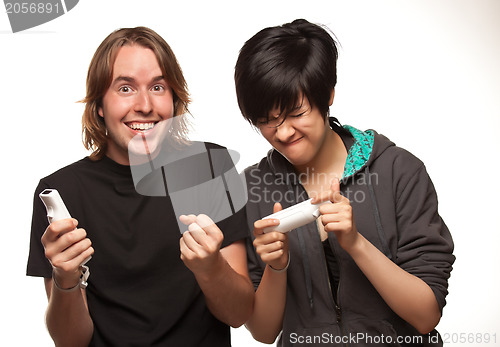 Image of Mixed Race Couple Playing Video Game Remotes on White