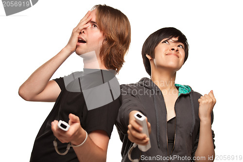 Image of Mixed Race Couple Playing Video Game Remotes on White