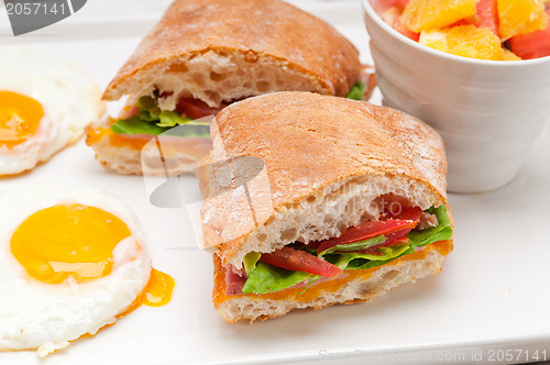 Image of ciabatta panini sandwich eggs tomato lettuce