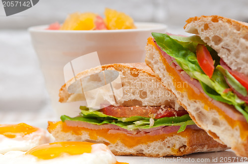 Image of ciabatta panini sandwich eggs tomato lettuce