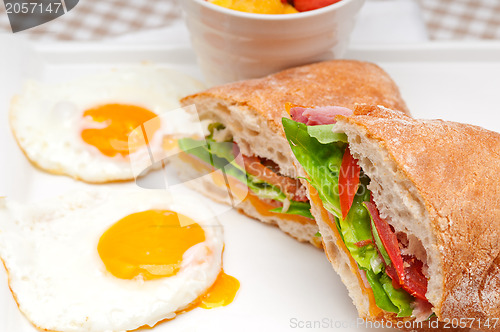 Image of ciabatta panini sandwich eggs tomato lettuce