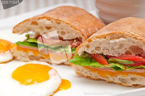 Image of ciabatta panini sandwich eggs tomato lettuce